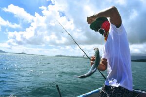 A man catches a fish in the sea