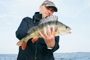 A man holding a grey fish 