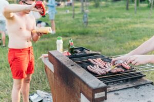 A man cooking sausage