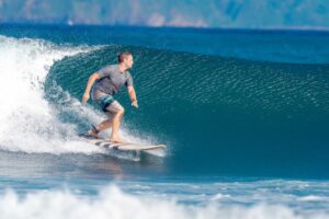 A man in a surfboard surfing 