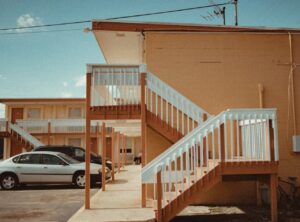 two vehicle park in front of a motel