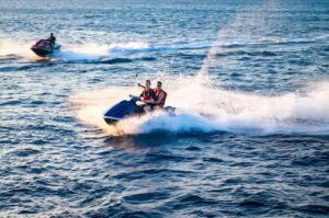 Two men riding in a jetski