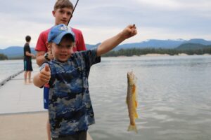 Kid catches a yellow dotted fish