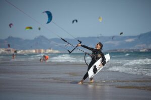 A girl holding a surfboard 