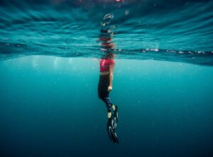 A girl on the ocean swimming