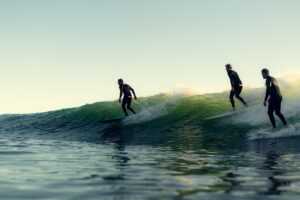 Group of men surfing in the beach