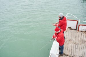 Two people fishing using Tackle