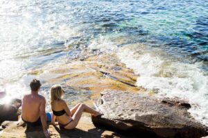 man and woman enjoying the view of the beach