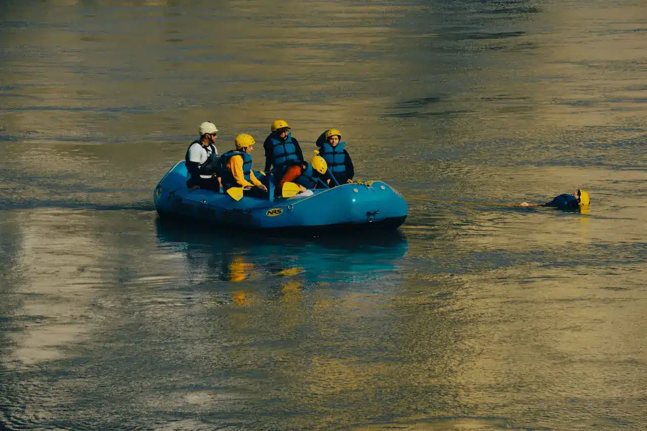 A Group of People Riding on a Raft in the Water