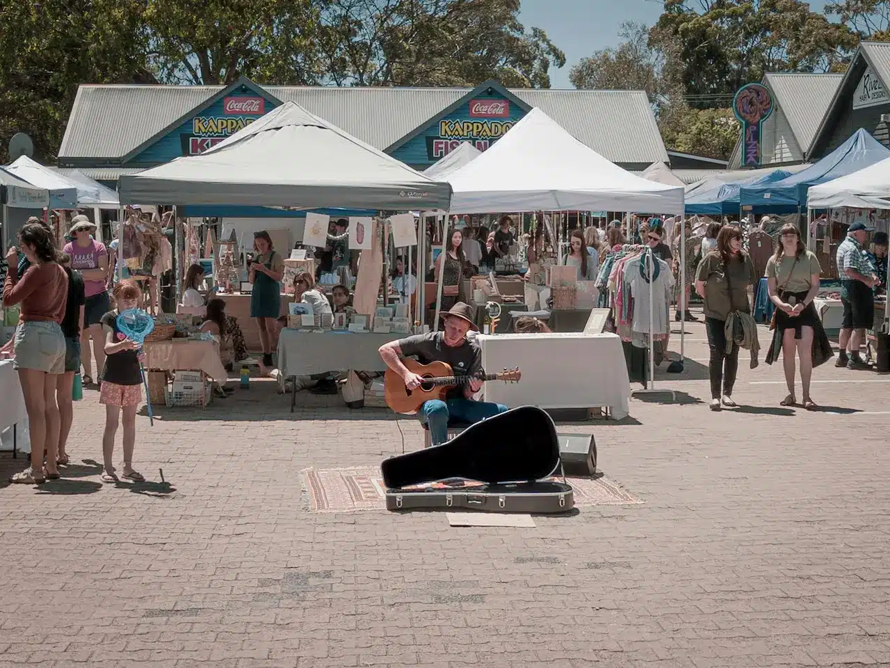 A Man Playing Guitar in Front of a Crowd in Margaret River